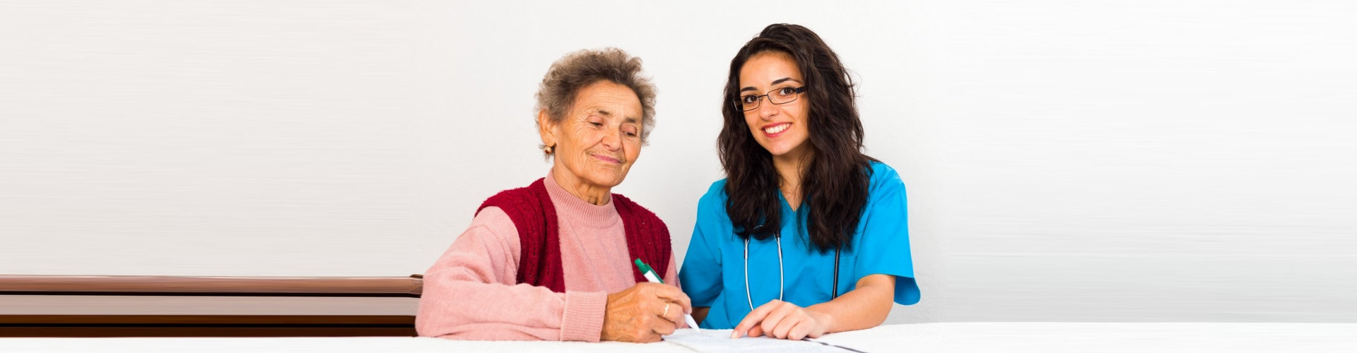 an elderly woman with a caregiver woman